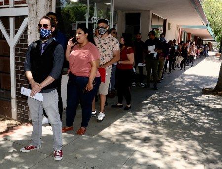 A long line of prospective employees on Saturday line up on D Street in downtown Lemoore for interviews for jobs at Natural Healing Center, one of two cannabis dispensaries in the city. NHC is expected to open in July.